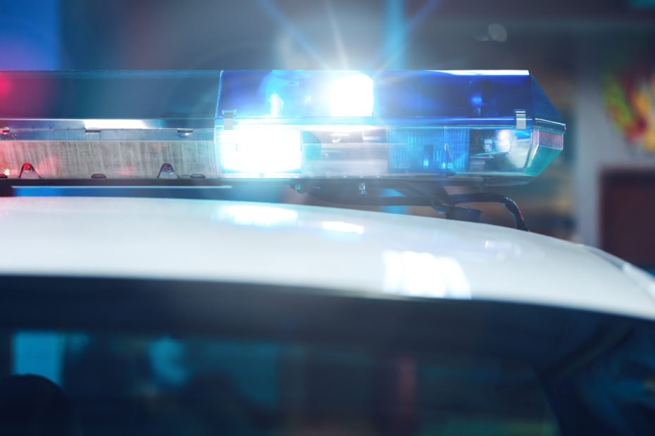 Police lights illuminated on top of a police car